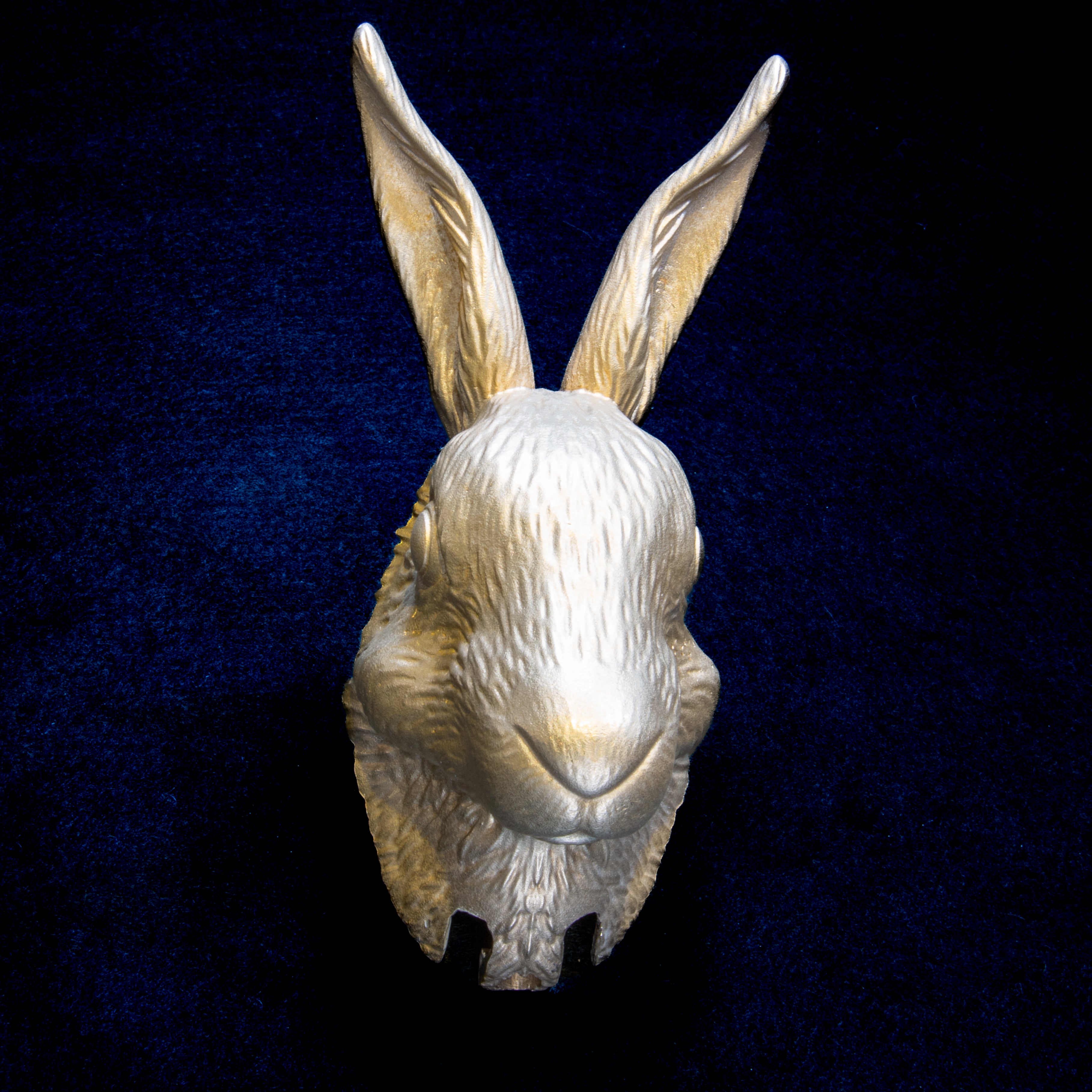 Easter collection: Hare door knocker head on navy cloth, front view, tall ears straight up above a soft rounded muzzle