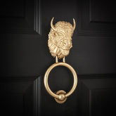 Bearded Bison brass door knocker, angled view on a black door