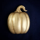 Pumpkin interchangeable door knocker head on navy, a plain uncarved pumpkin with deep ribs and a twisted stalk