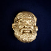 Santa interchangeable door knocker head, front view on navy cloth, hat tipped to one side, bobble by the ear, full beard
