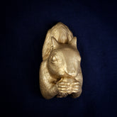Grey Squirrel interchangeable door knocker head on a navy background, front view, nut held in both paws, tail raised behind