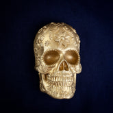 Marigold Sugar Skull interchangeable door knocker head on navy, front view, a flower on the brow and open eye sockets