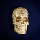 Rose Bloom Sugar Skull interchangeable door knocker head on navy, front view, a rose on the crown and open eye sockets