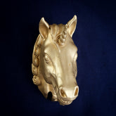 Scottish Unicorn interchangeable door knocker head on navy cloth, three-quarter view, spiral horn and teeth showing