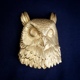 Owl interchangeable door knocker head, front view on navy cloth, ear tufts raised over round eyes and layered breast feathers