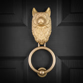 Husky brass door knocker fitted to a black front door, straight on
