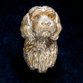 Cavapoo interchangeable door knocker head on a dark blue background, front view, long wavy ears framing a shaggy muzzle