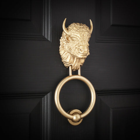 Beardless Bison brass door knocker, angled view on a black door