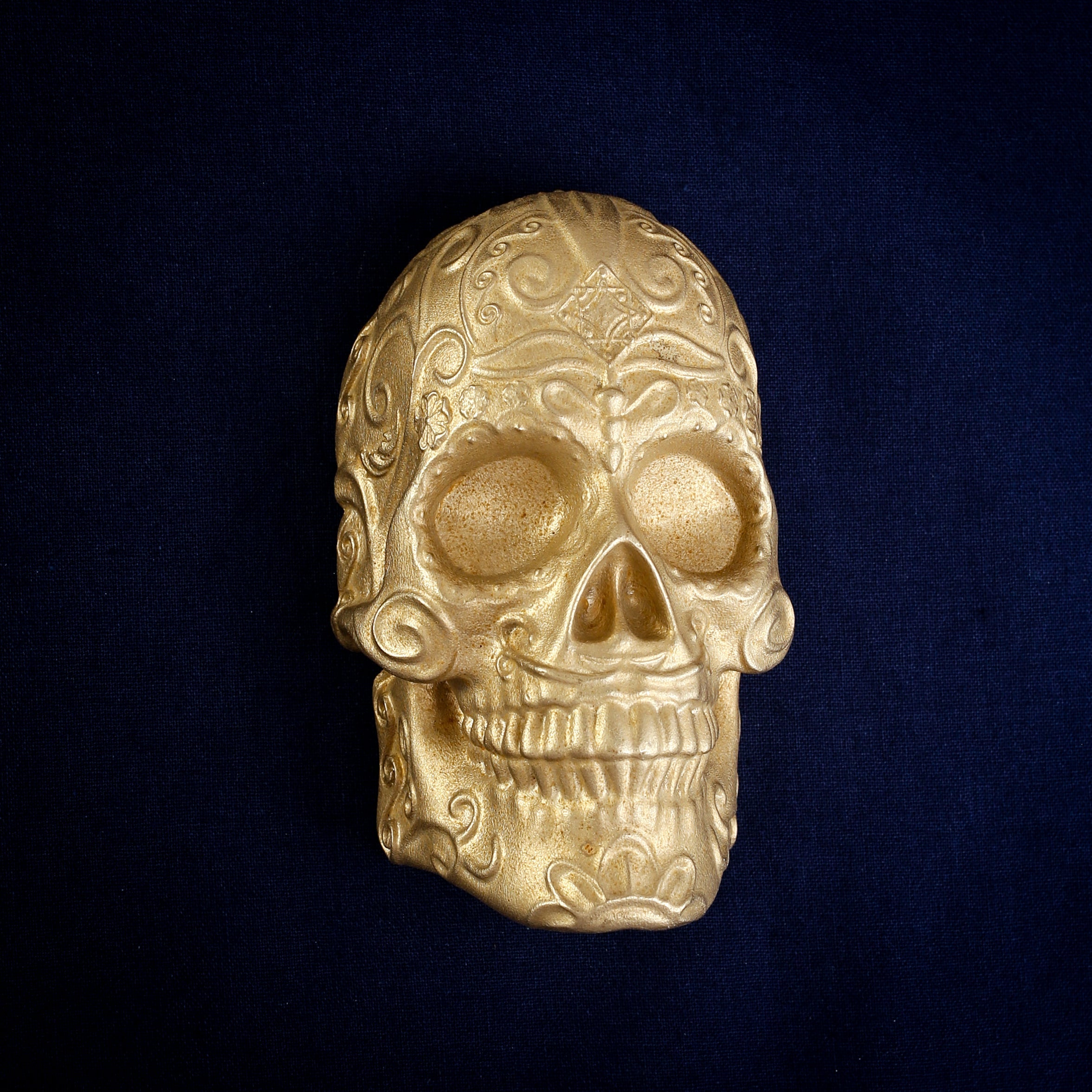 Delicate Scroll Sugar Skull interchangeable door knocker head on navy, front view, scrolls curling over the brow and cheeks