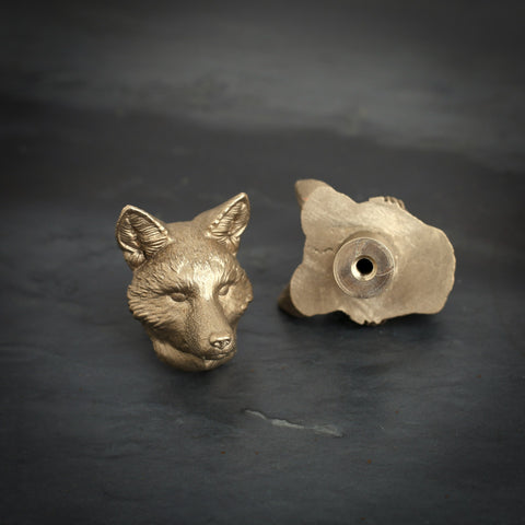 Fox brass cabinet knob and coat hook on dark slate, one facing front, one turned to show the threaded back