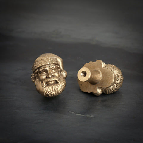 Santa brass cabinet knob and coat hook on dark slate, one facing front, one turned to show the threaded back