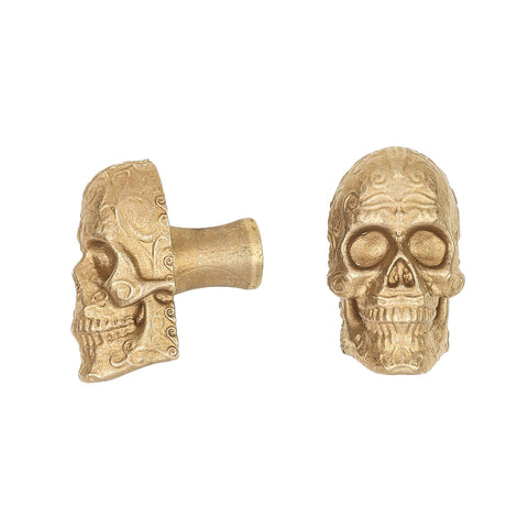 Sugar Skull brass cabinet knob and coat hook, cut out on white, one in profile showing the stem, one front on with scrollwork